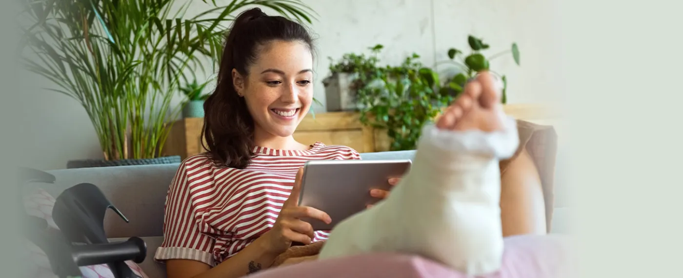 Woman with broken leg using crutches